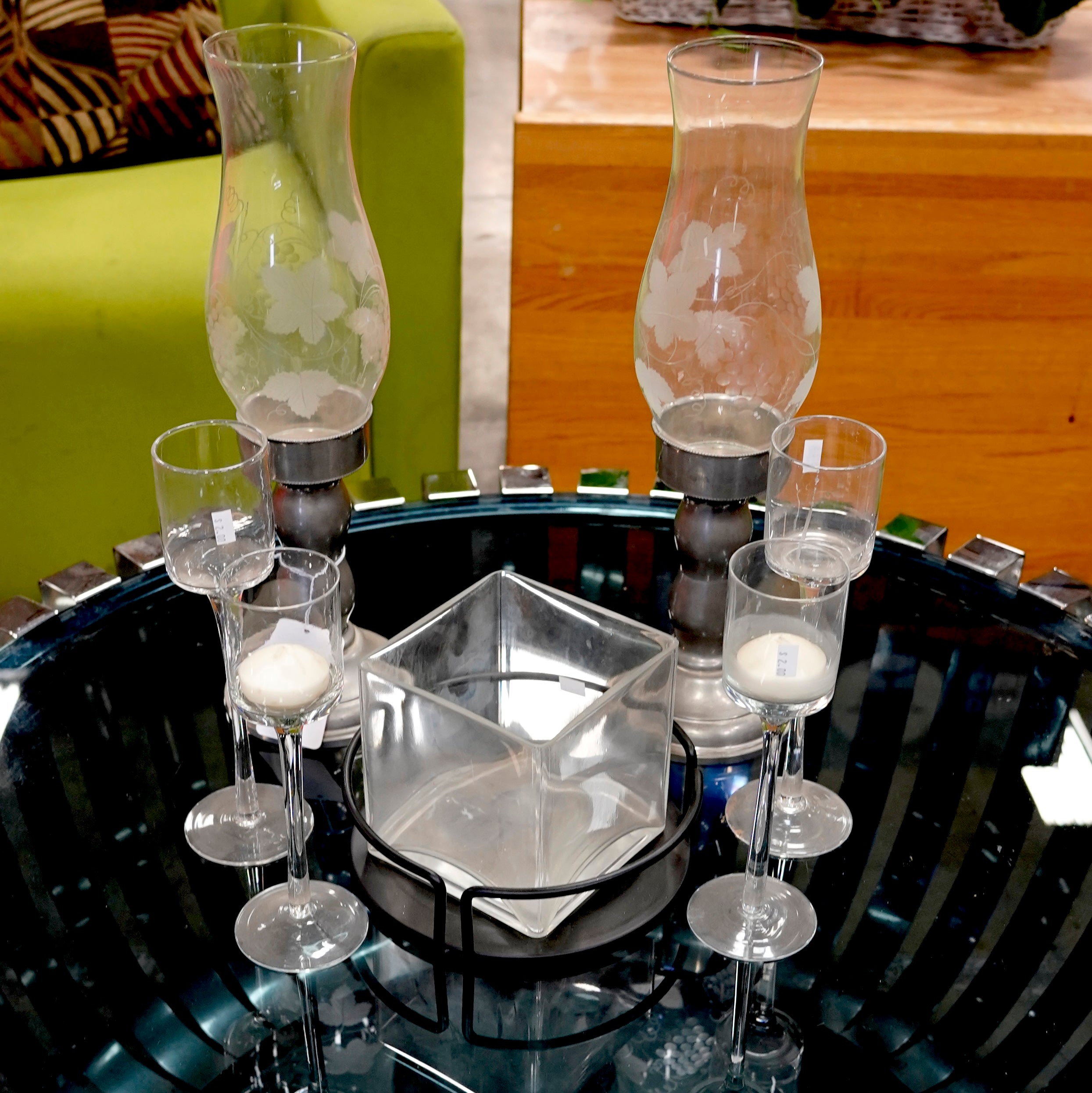 A selection of glass candle holders in varying sizes and styles.