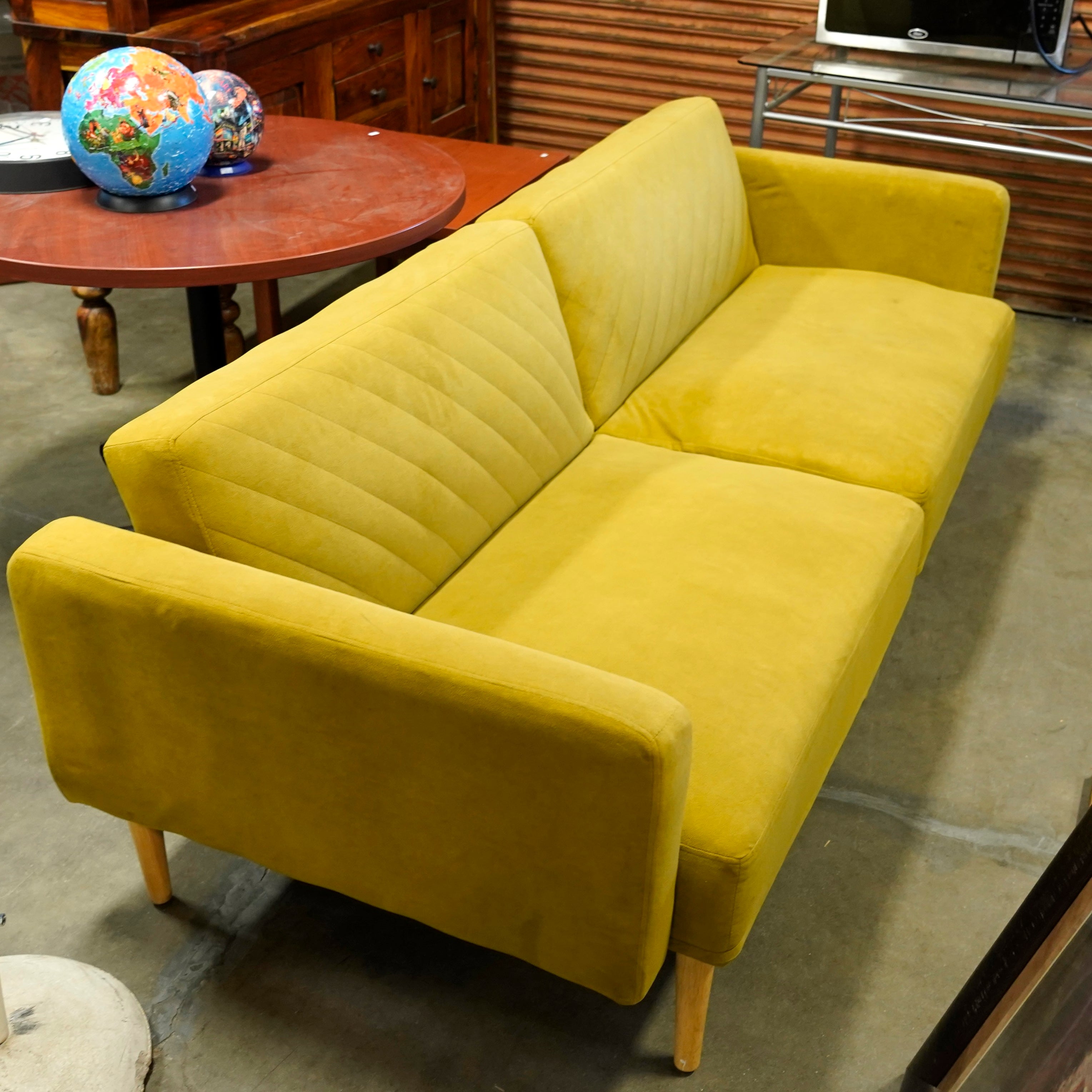 A funky yellow couch that's really cuts the mustard.