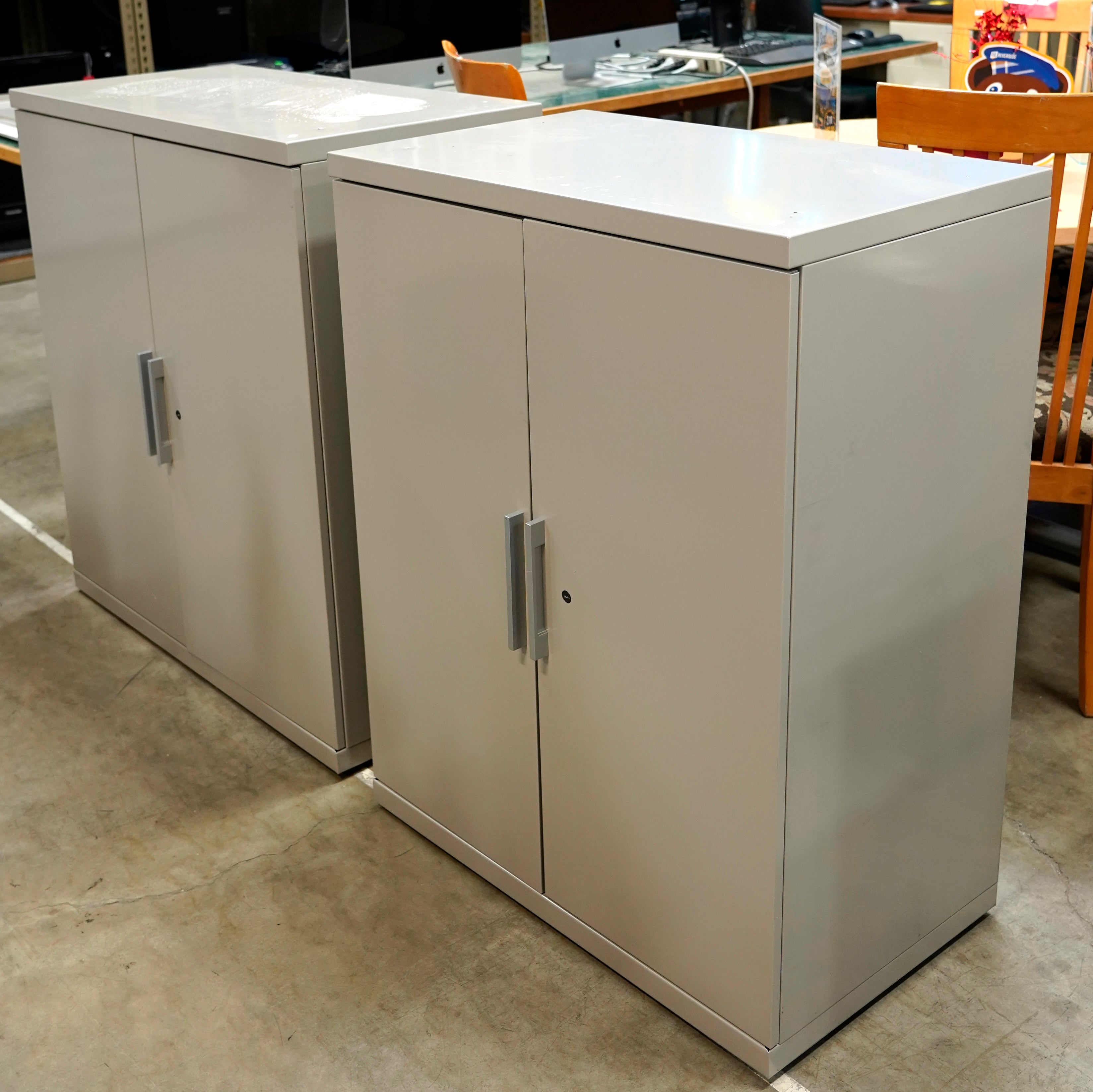 Two off-white 3-shelf metal cabinets.
