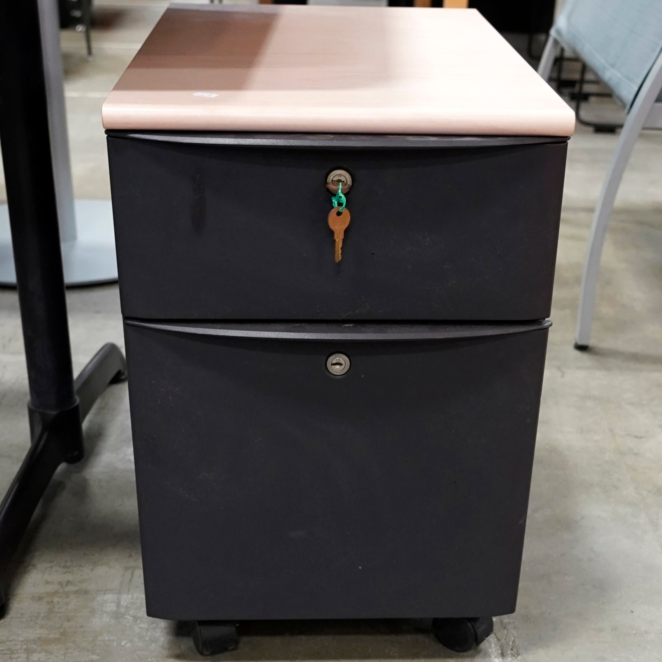 Locking 2-door gray file cabinet on wheels with key.
