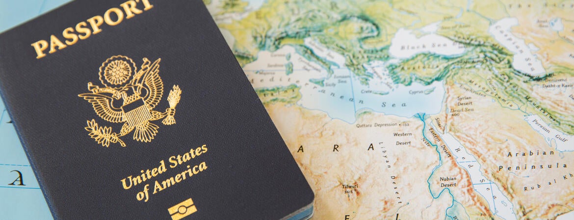 US Passport book on top of a world map.