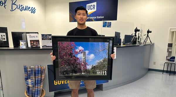 Han Li R'Card Contest Winner with framed winner