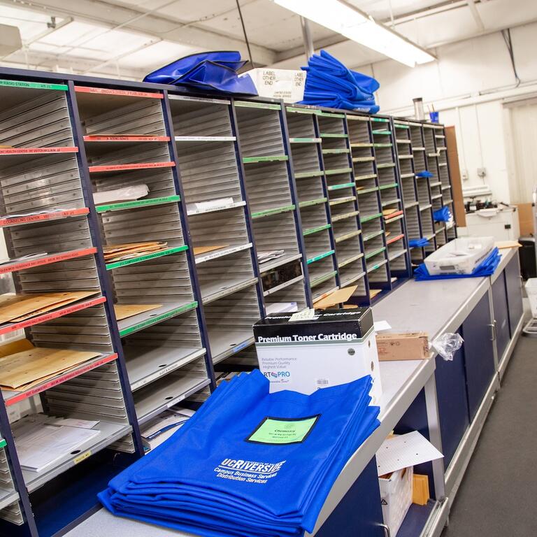 Interior of UCR Mail Services mail room with mail sorted into cubbies.