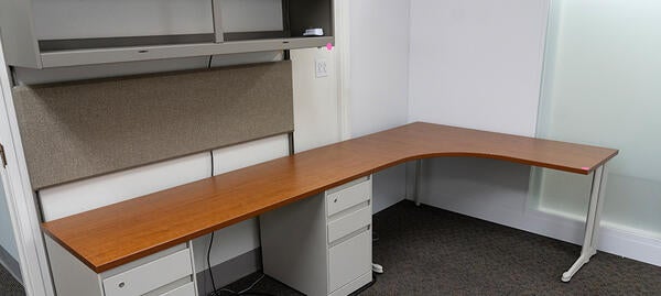 L-shaped wood desk with upper cabinets