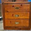 A three-drawer wooden side table