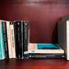 Classic books on a red-wood bookshelf