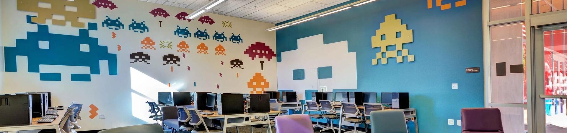 Space Invaders cutouts on a brightly colored wall.